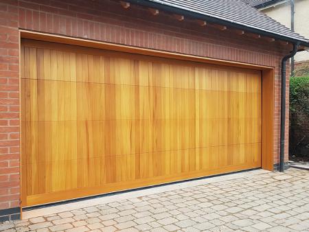 Light oak timber sectional door with vertical double fully finished back fix